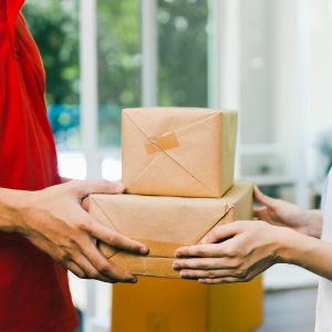 a-person-handing-over-boxes-ppe