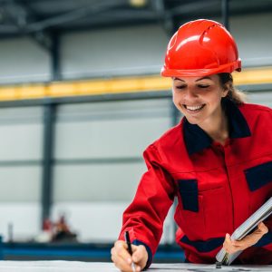 a-women-dressed-in-ppe-drawing-construction-plans